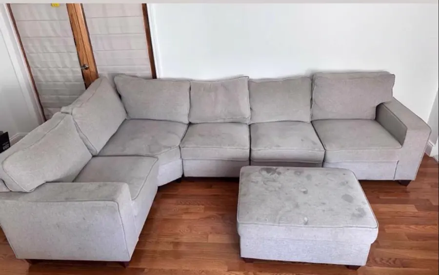 Before cleaning: gray U-shaped sectional with ottoman