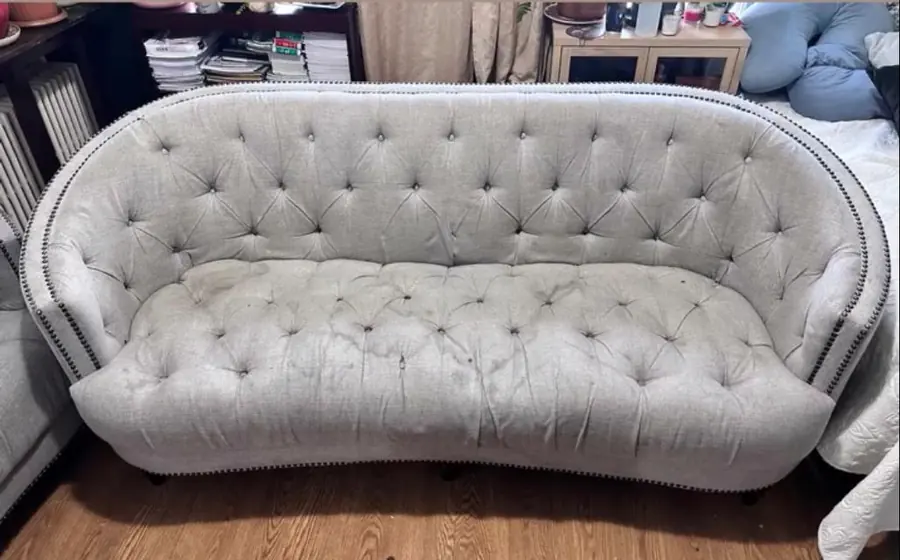 Before cleaning: tufted gray loveseat